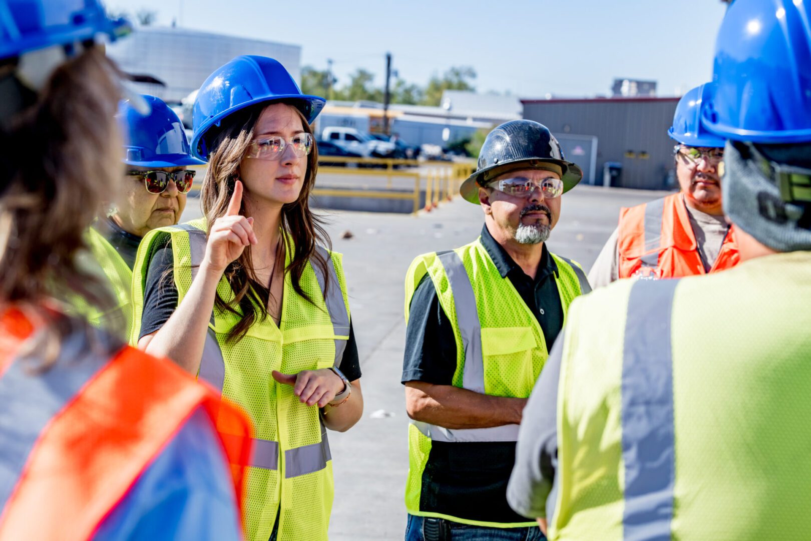 A group of people in hard hats and vests.