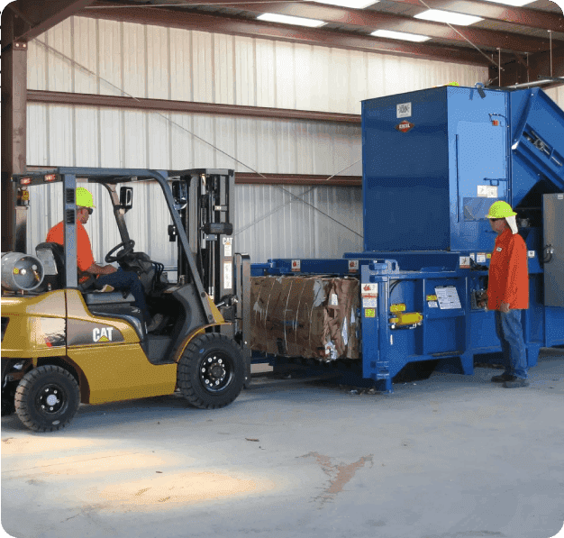 A forklift is loading a large blue container.