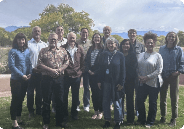 A group of people standing in the grass.