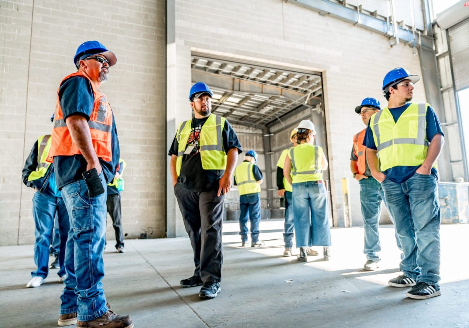 A group of construction workers standing next to each other.